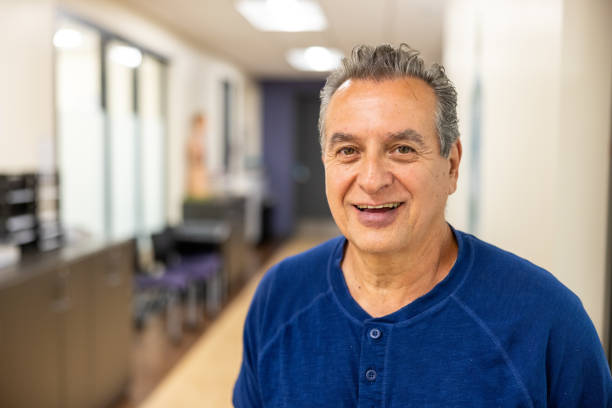 a portrait of a senior man in a medical facility.